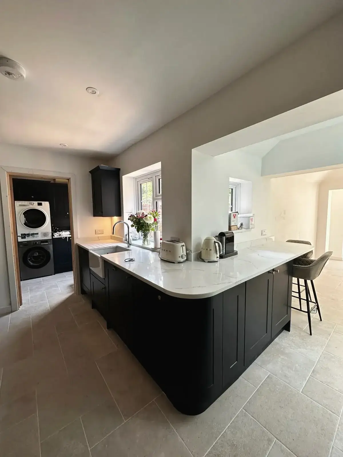 Black shaker-style cabinets with marble kitchen island