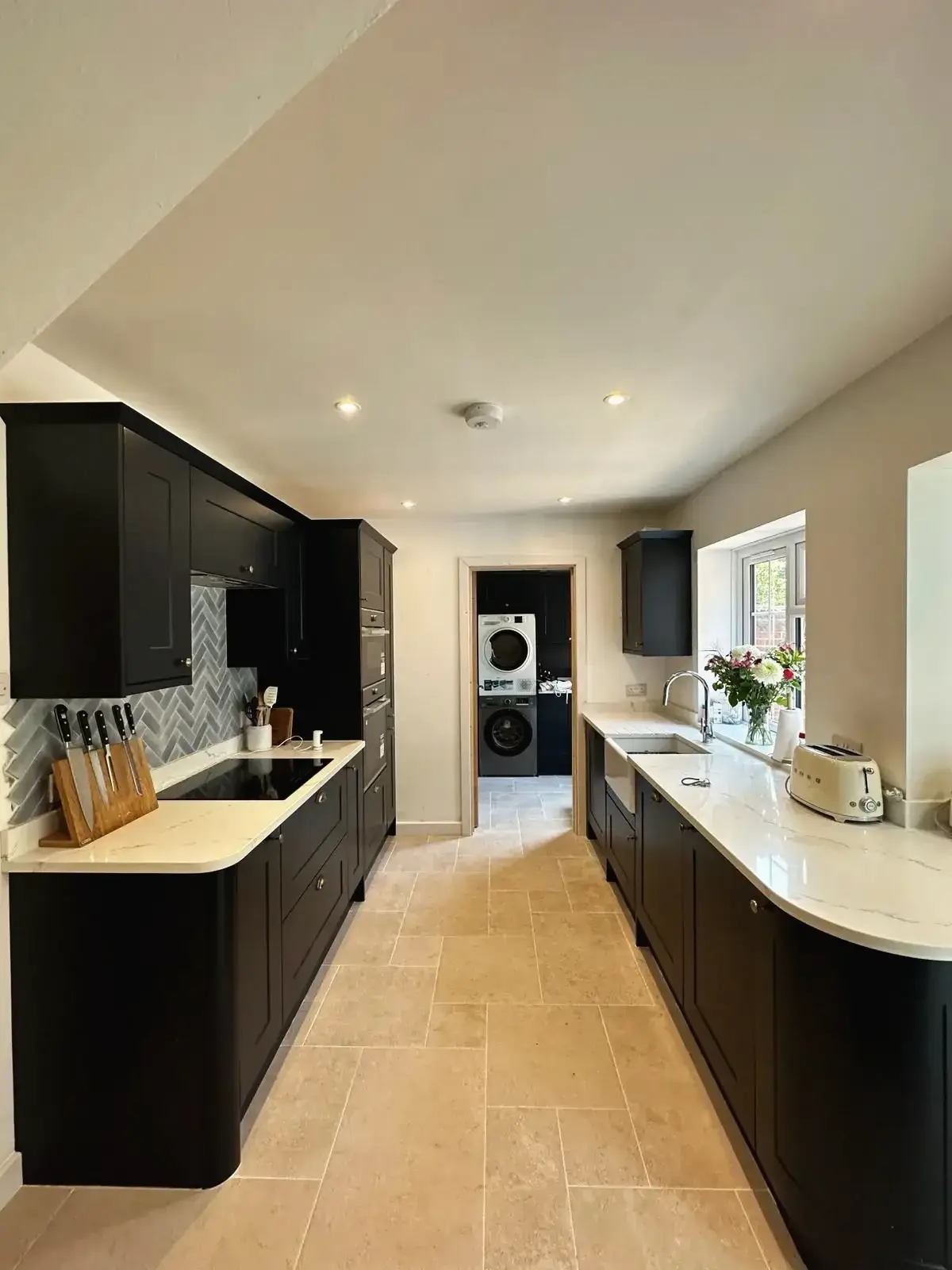 Black shaker-style cabinets with marble kitchen island