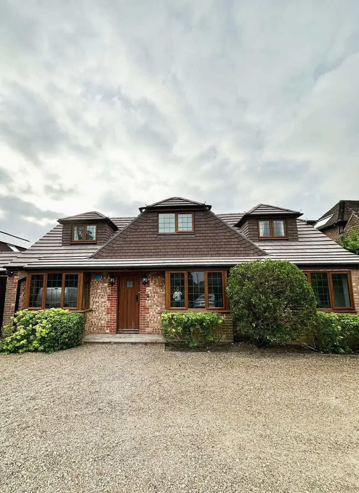 Brick house with dormer windows after renovation