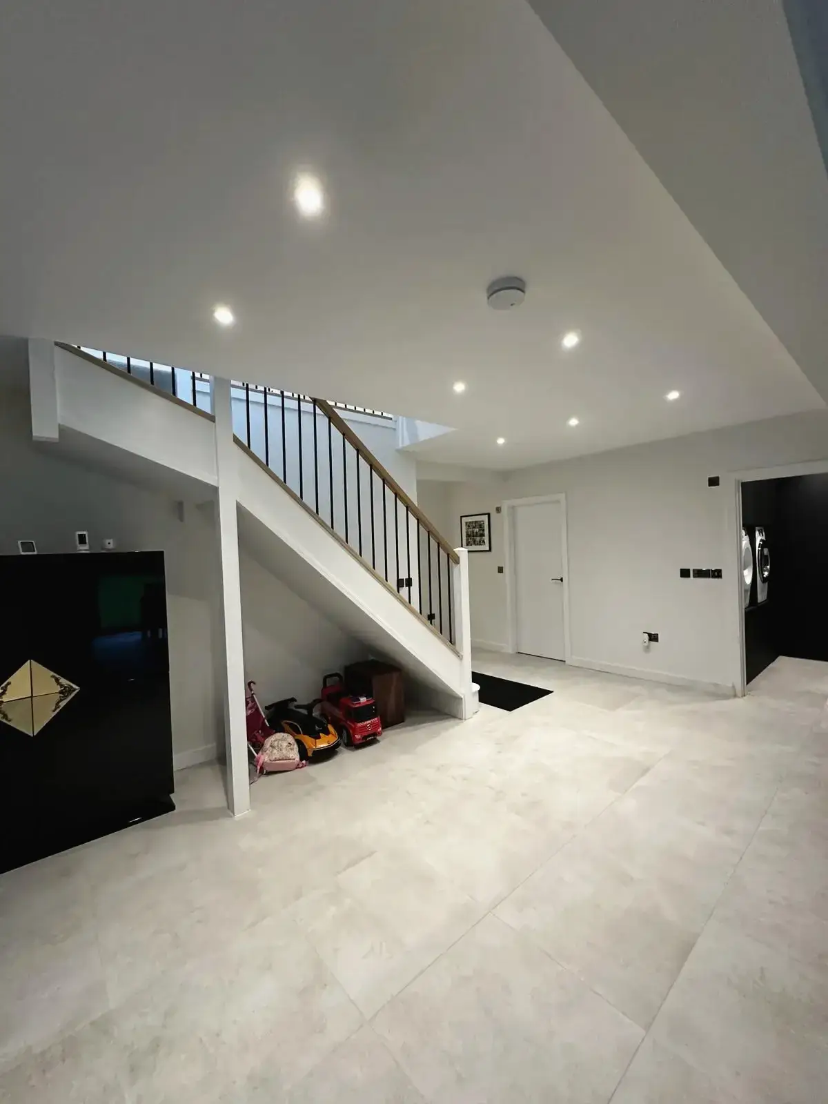 Bright hallway with under-stairs storage space and spotlights renovation