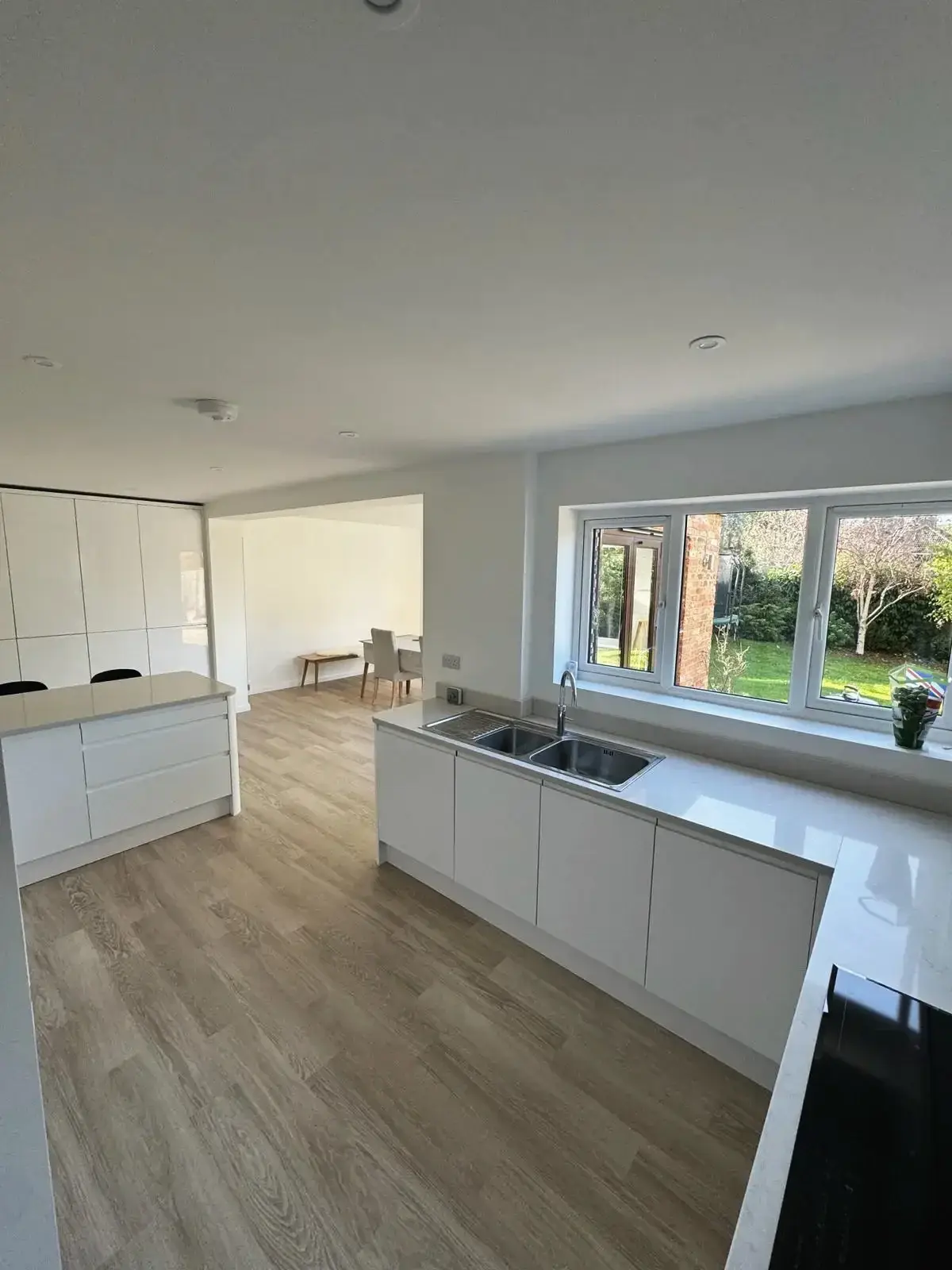 Bright modern kitchen with double sink and garden view