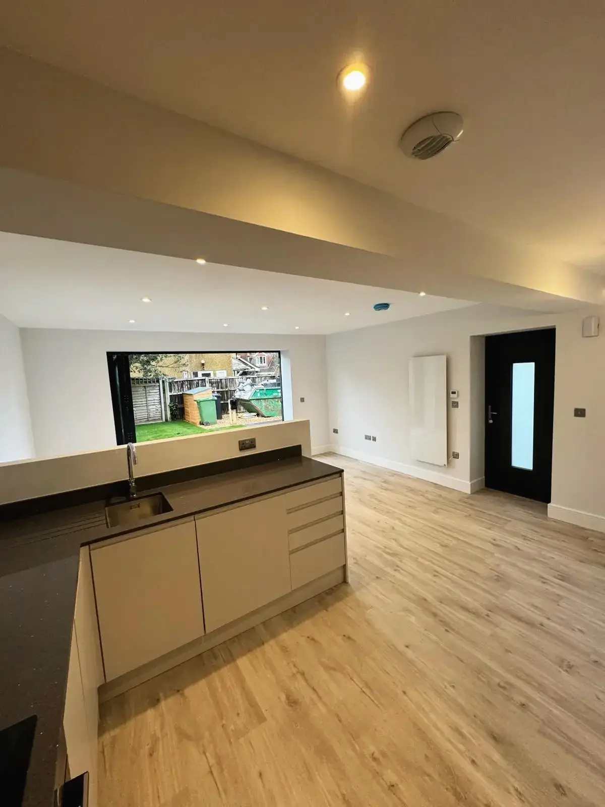 Bright open-plan kitchen and lounge area with patio access
