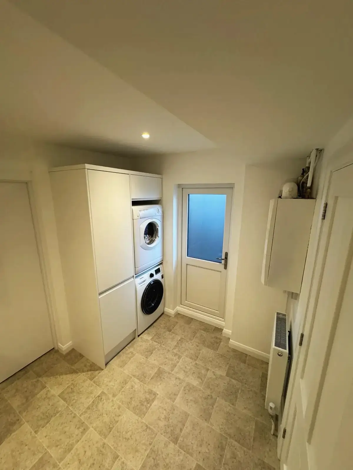 Compact and functional laundry room design next to the kitchen