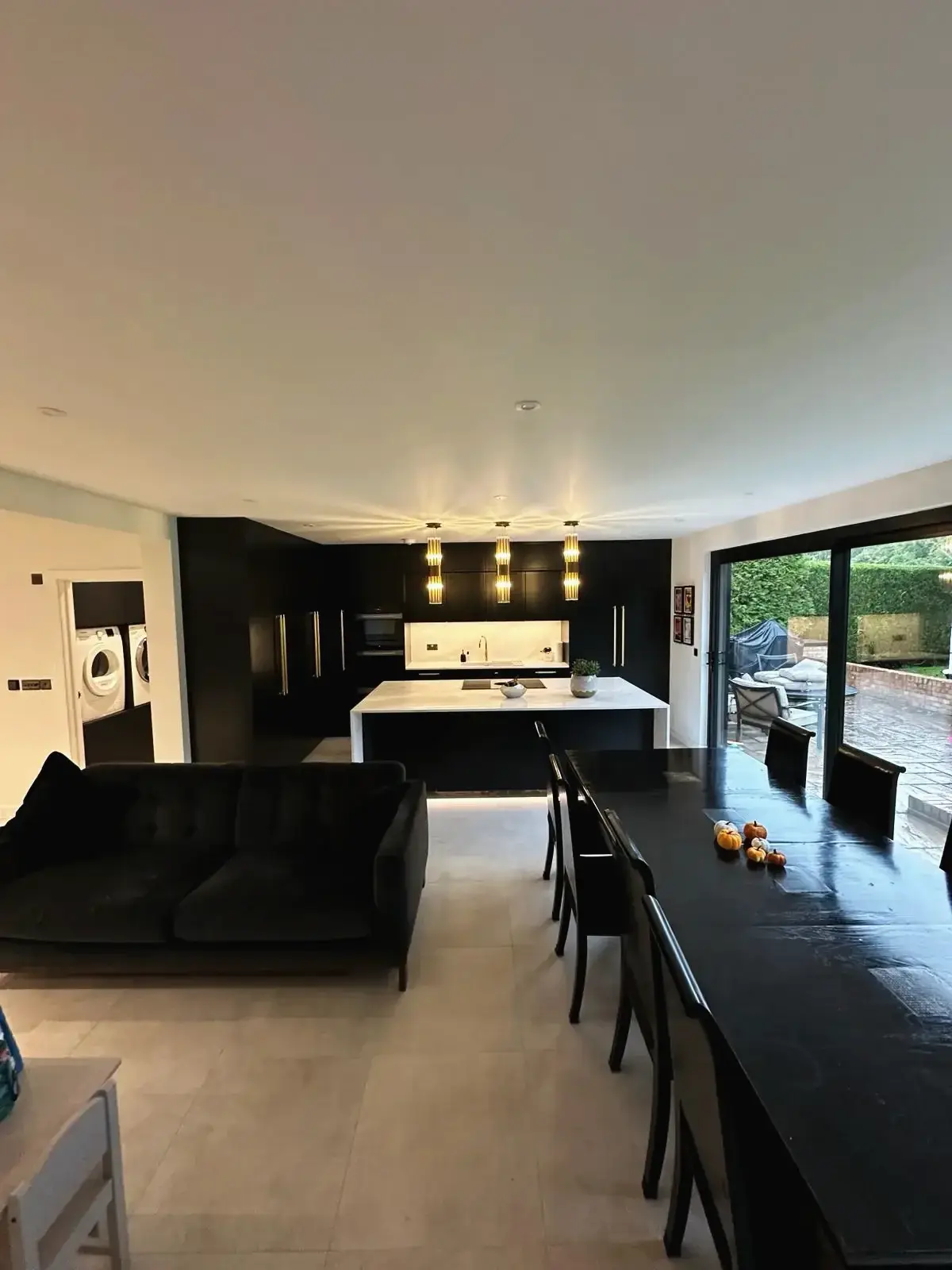Contemporary kitchen island and dining table with pendant lights