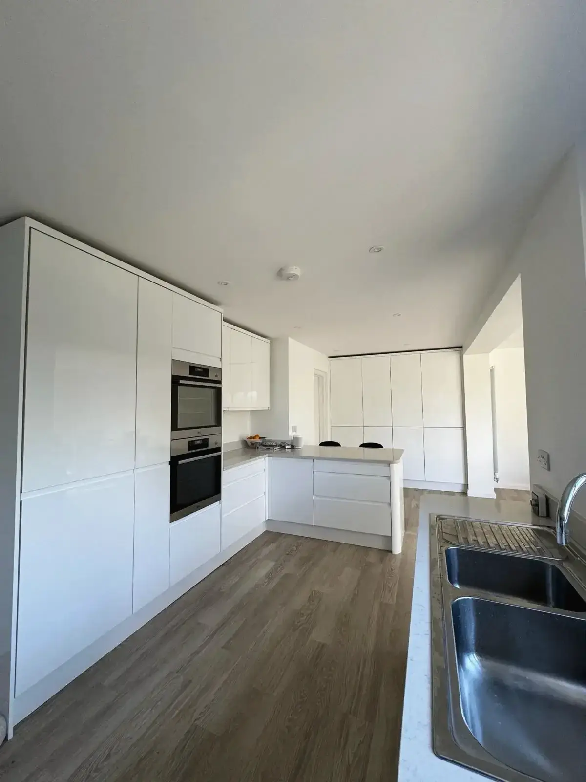 Contemporary kitchen with integrated double ovens and central island