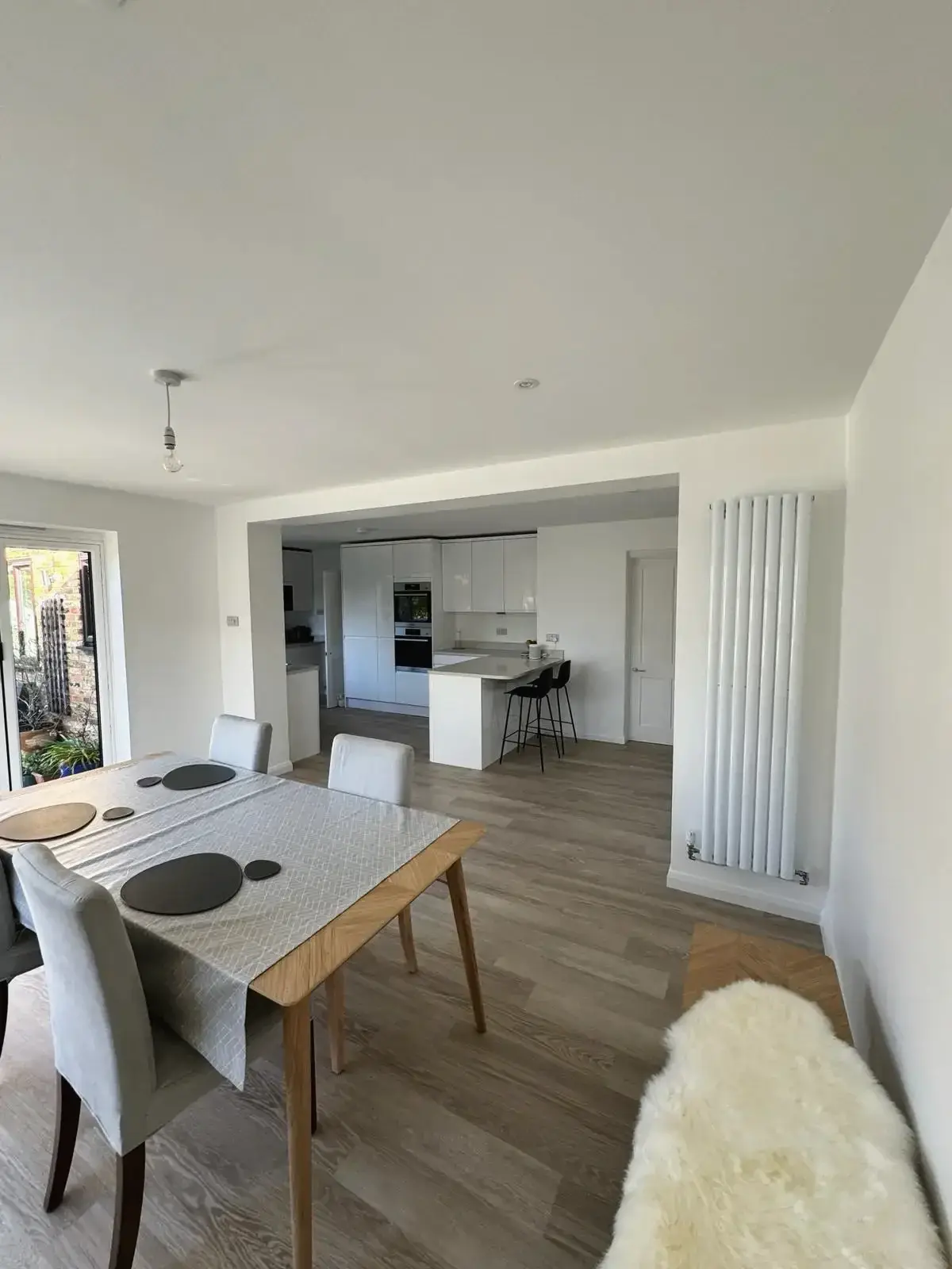 Dining area renovation featuring large window and outdoor access