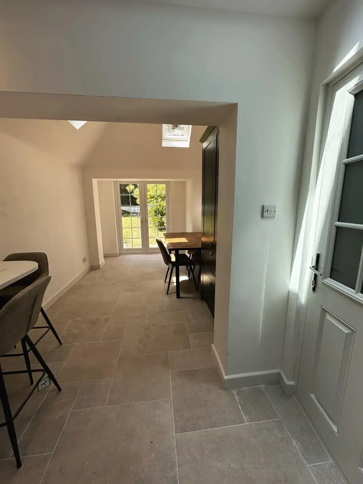 Dining area with skylight and patio doors