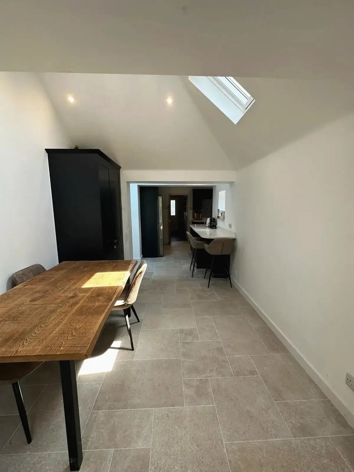 Dining area with skylight and wooden table