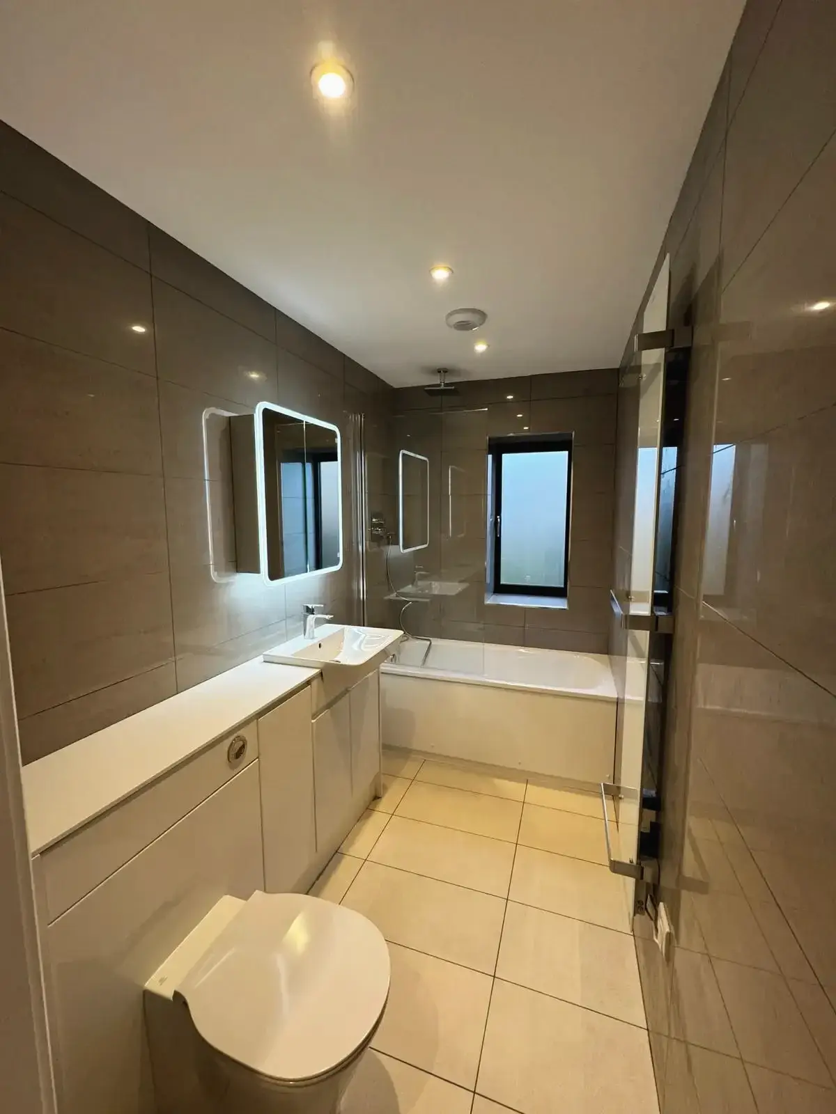 Elegant bathroom with bathtub, floating sink, and modern lighting