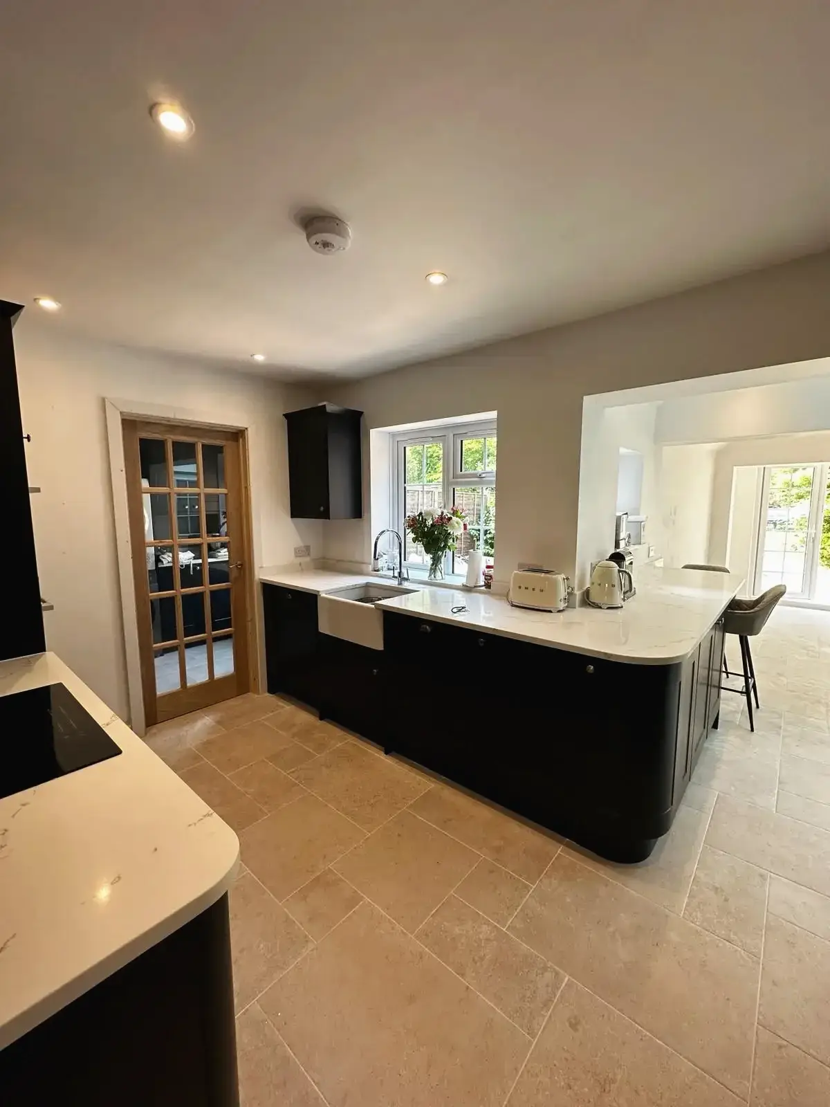 Elegant kitchen design with dark cabinets and white worktop