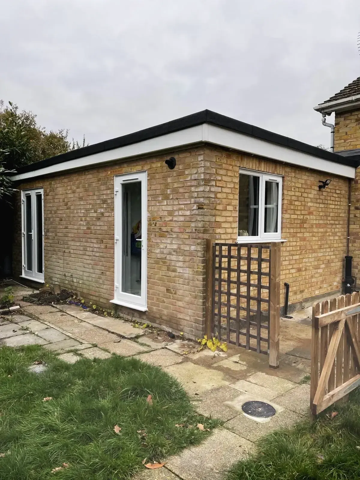 Flat roof brick extension at rear of house