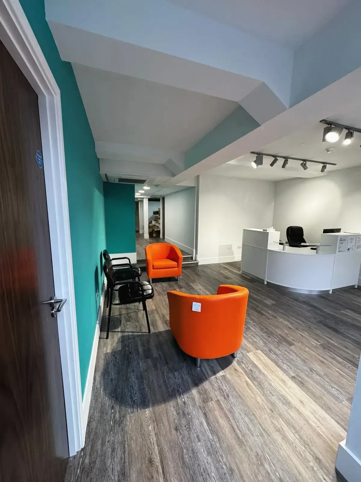 Full view from main door of a modern medical clinic reception area created during a loft conversion in Chobham
