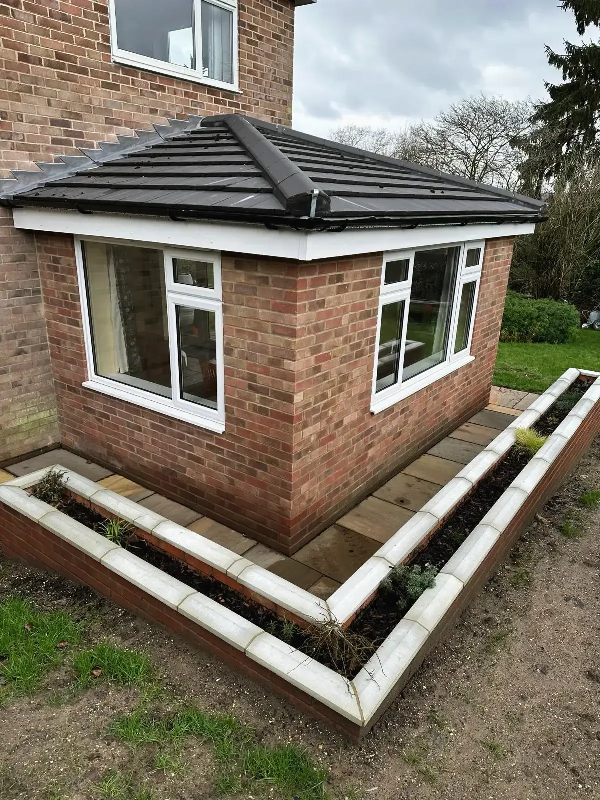 Ground floor brick extension with garden planter walls