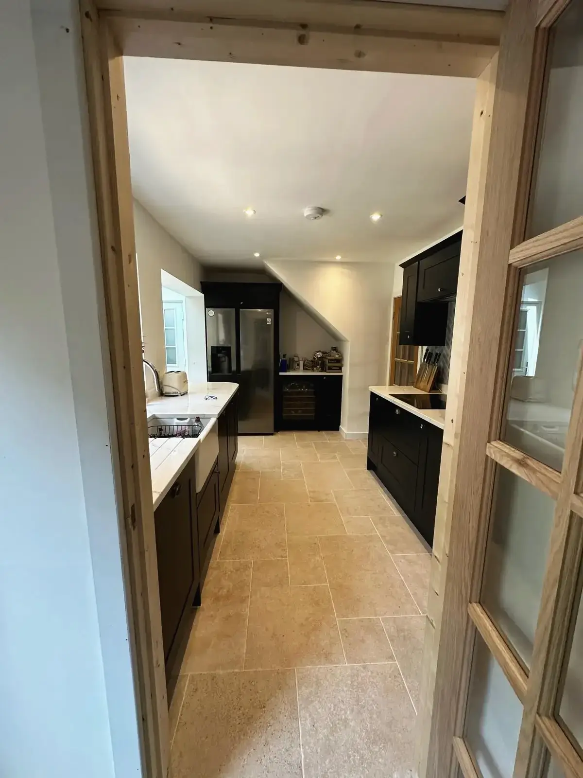 Kitchen entrance with oak frame and tiled flooring