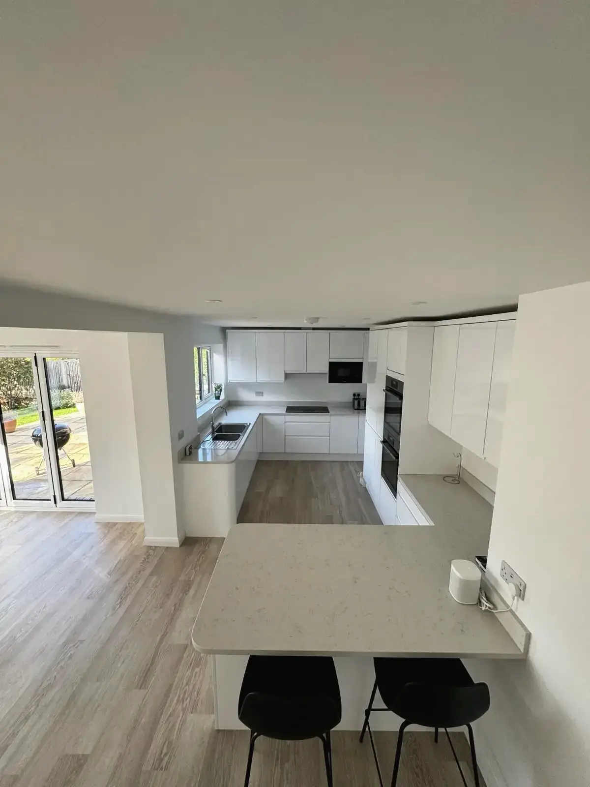 Luxury kitchen renovation featuring island seating and storage units