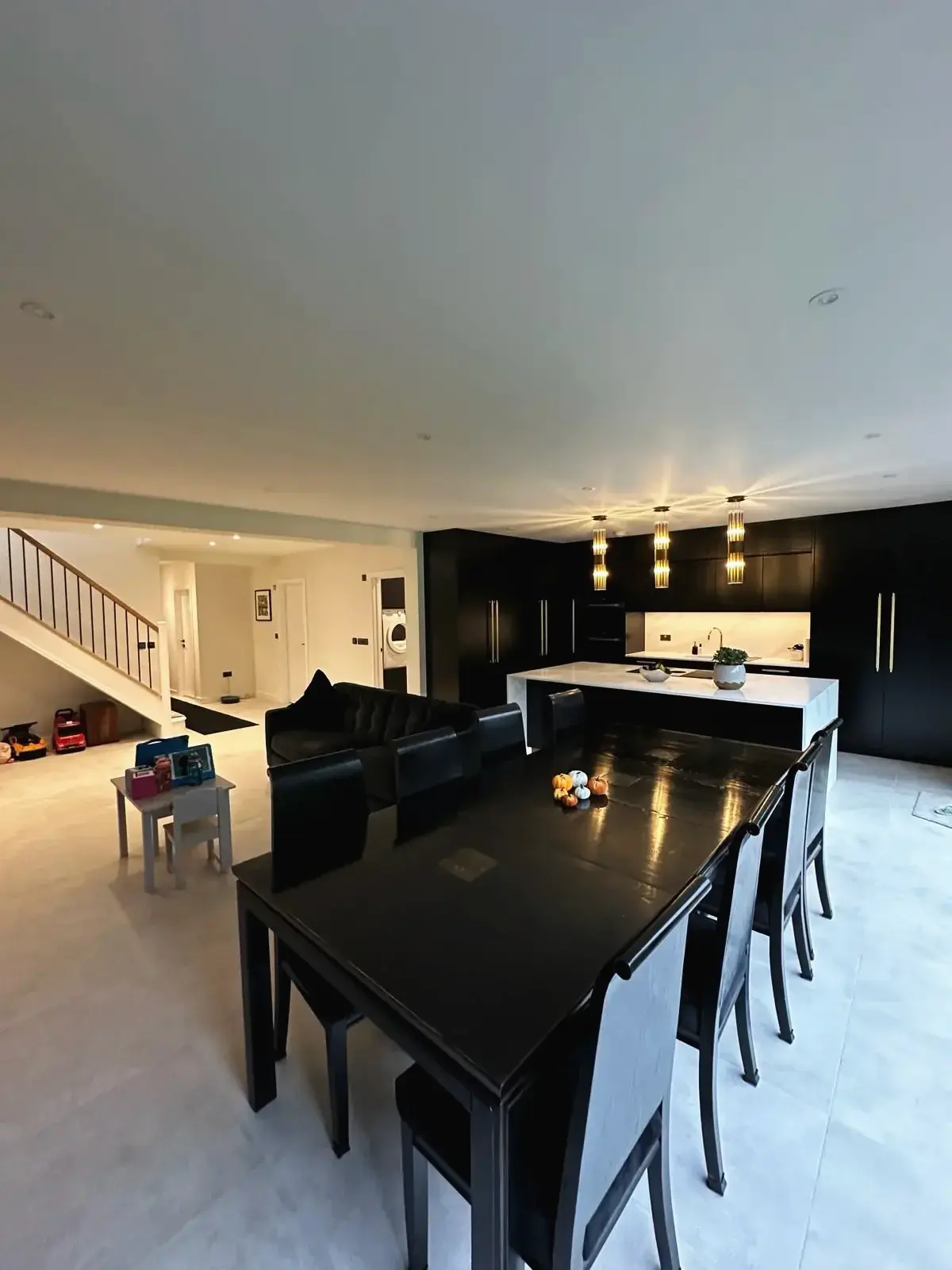 Luxury open-plan dining and kitchen layout with bright lighting