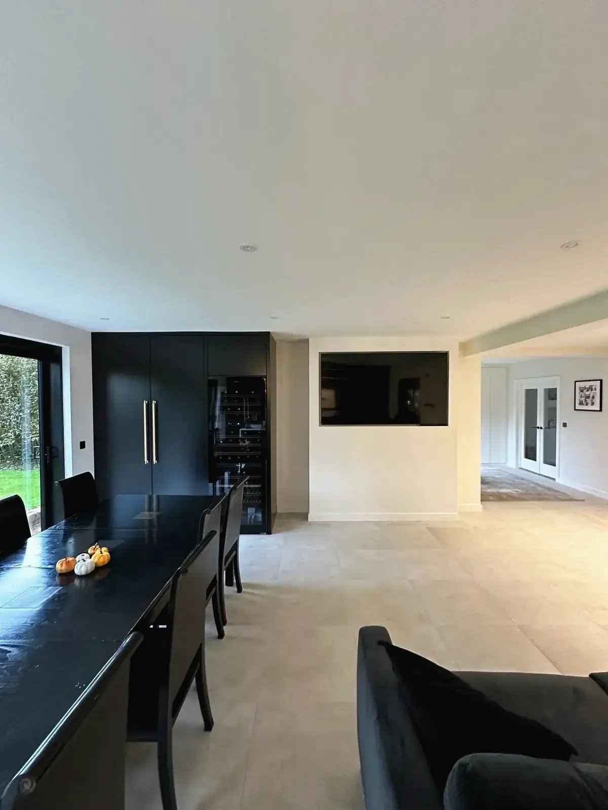 Modern dining room with black furniture and open-plan interior