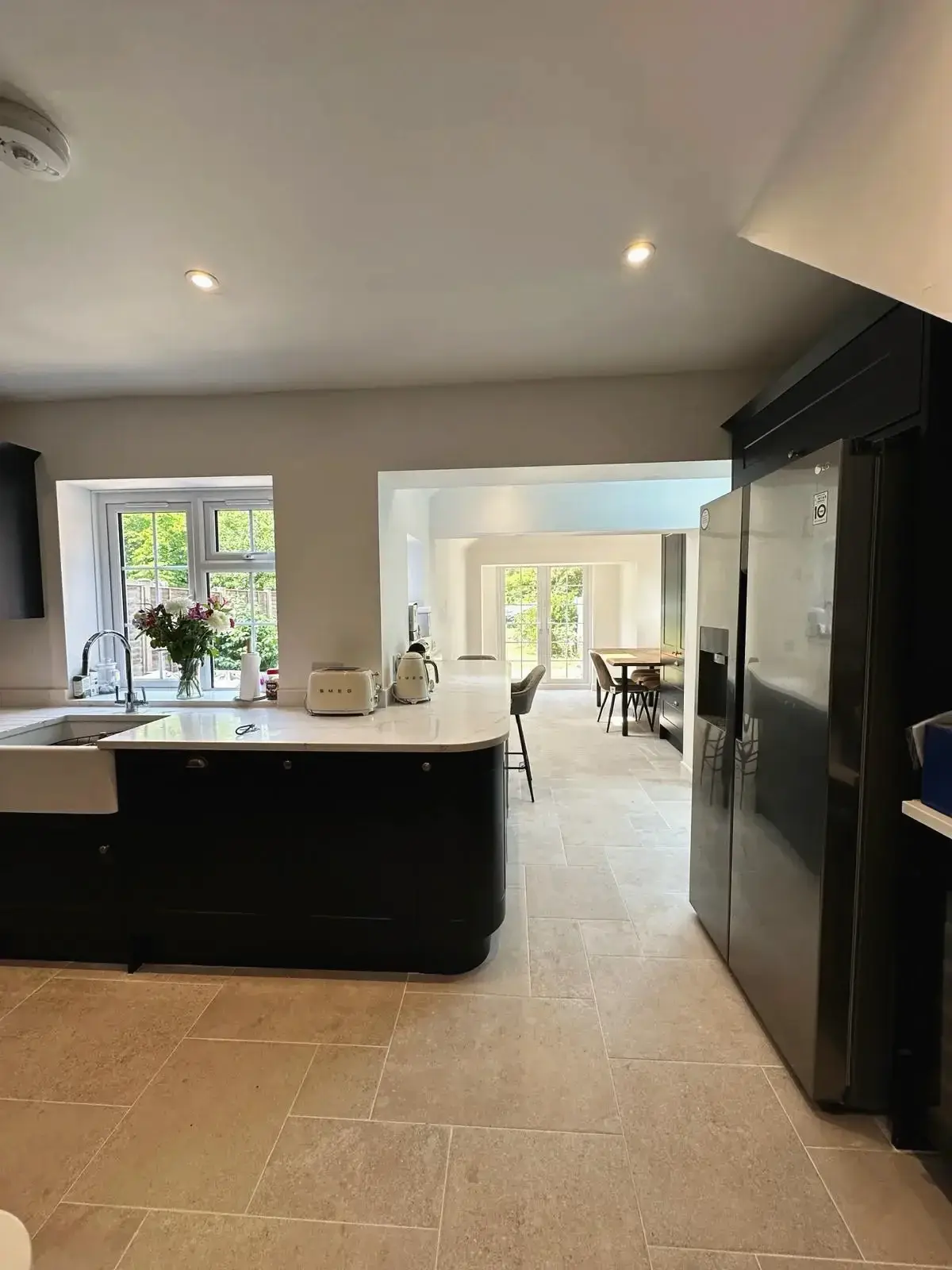 Modern kitchen renovation with breakfast bar and dining table