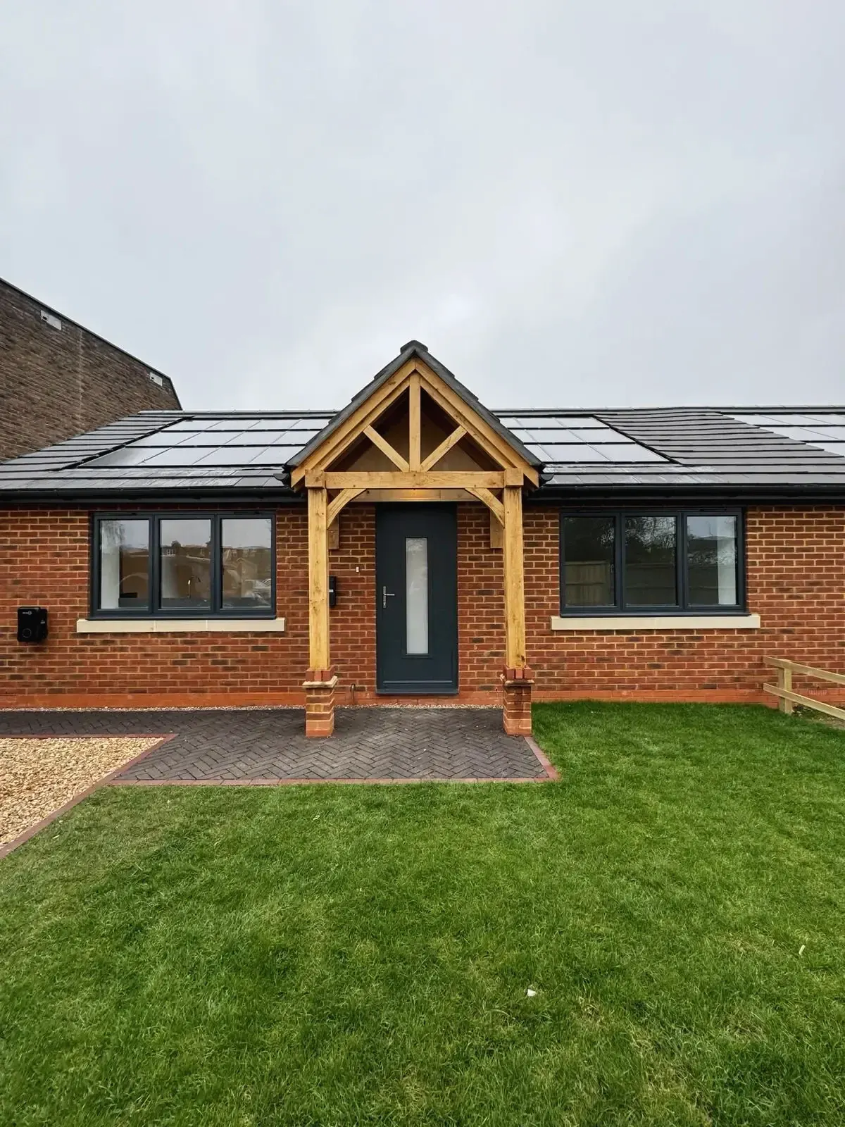 New build house with oak framed entrance and landscaped garden