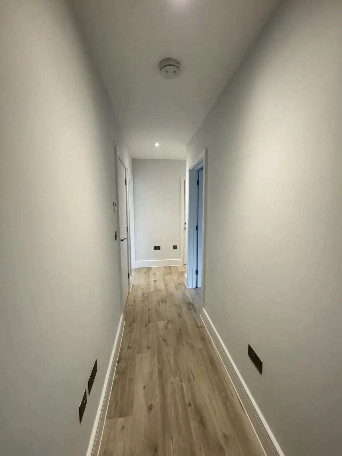 New build interior passage with smoke alarm and recessed ceiling lighting