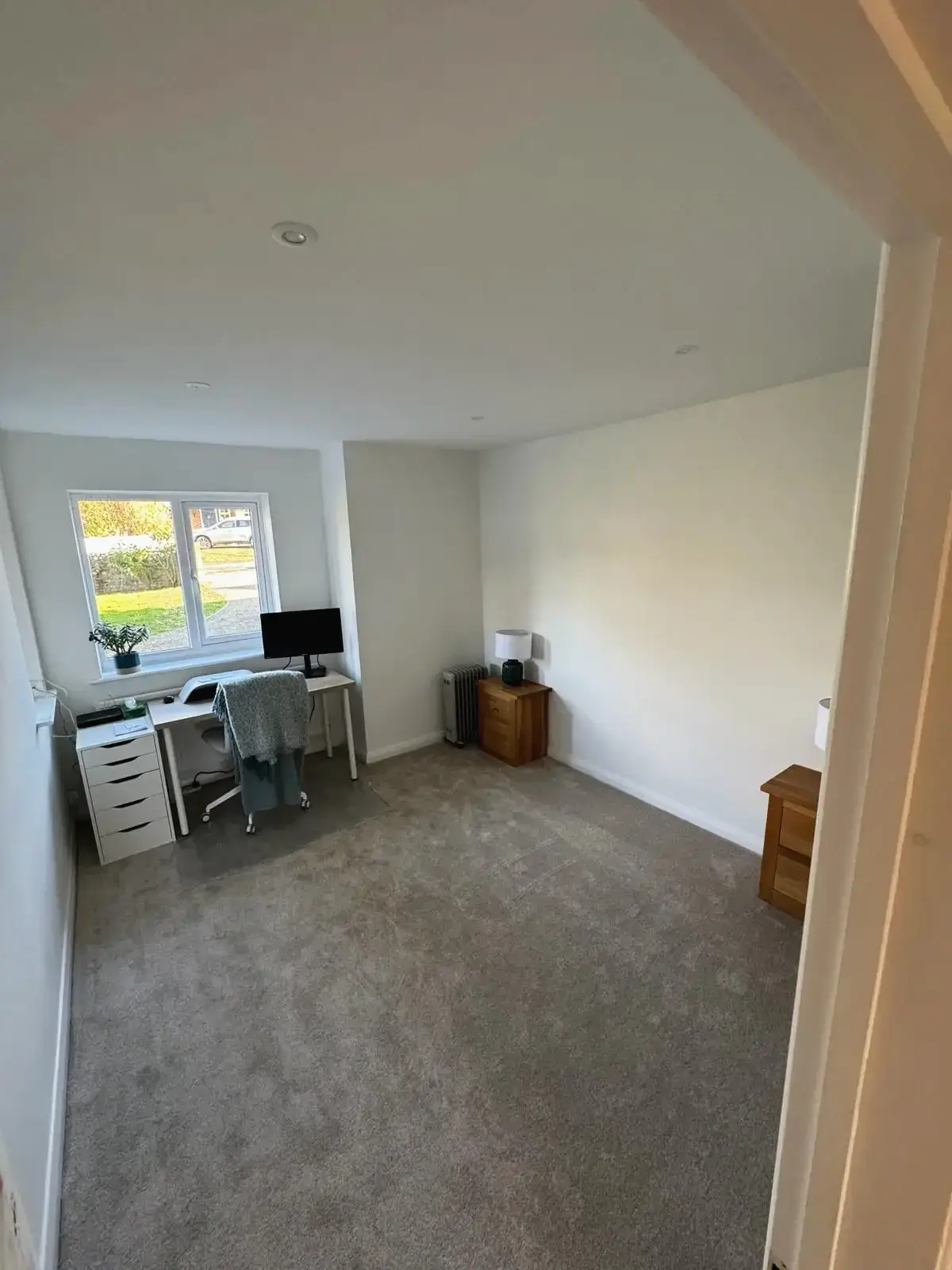 Refurbished home office with carpet flooring and modern design