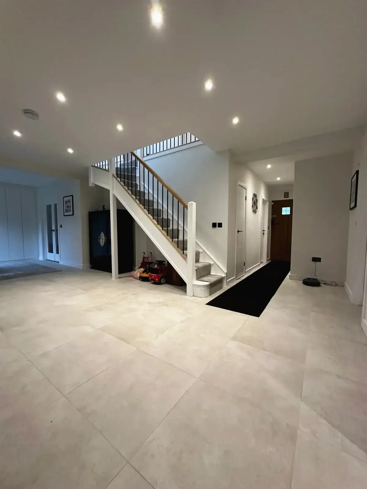 Renovated entrance hall with bright lighting and staircase