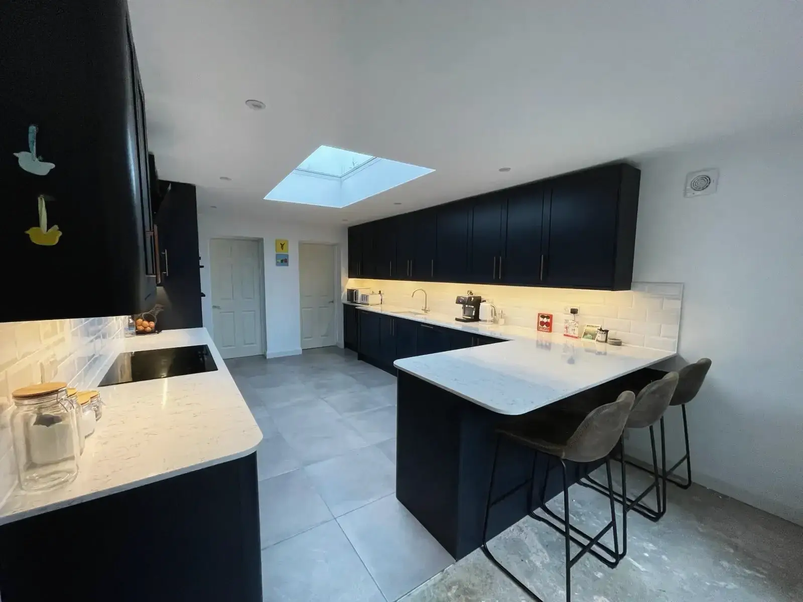 Renovated kitchen space with skylight and French doors
