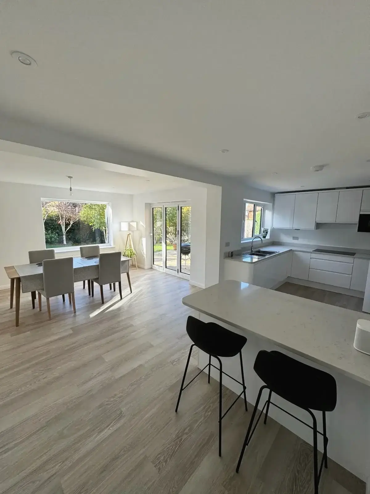 Renovated open-plan living space with breakfast bar and dining area