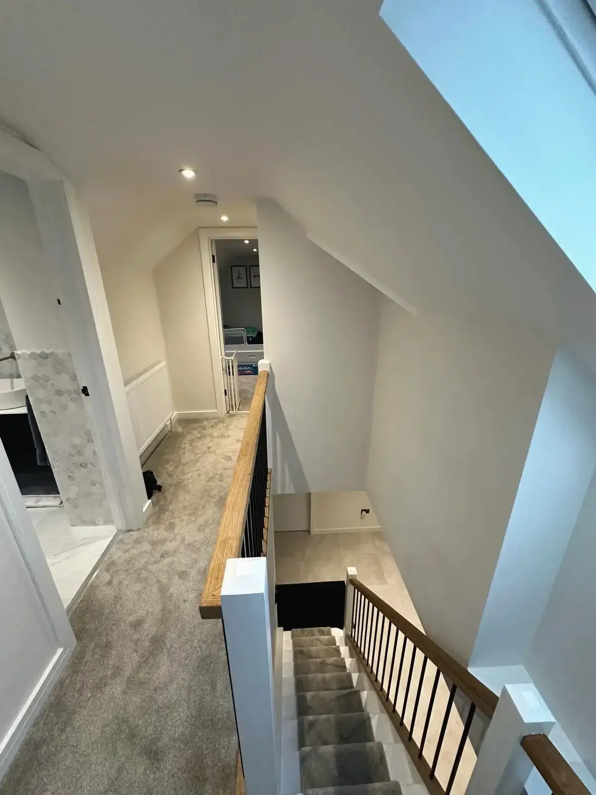 Right upstairs landing with skylight, railings, and staircase renovation