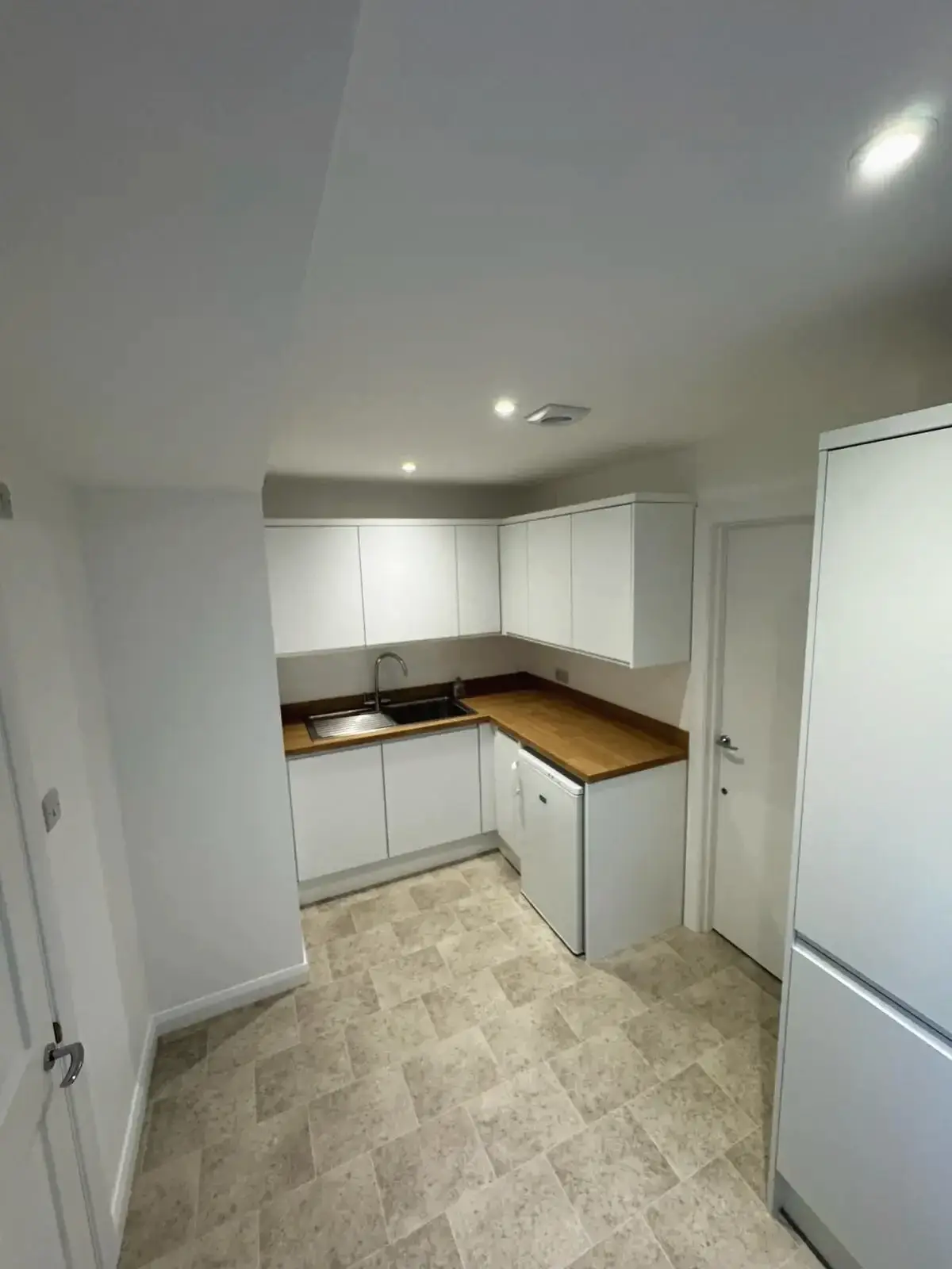 Stylish kitchen refurbishment featuring modern cabinetry and wooden countertops