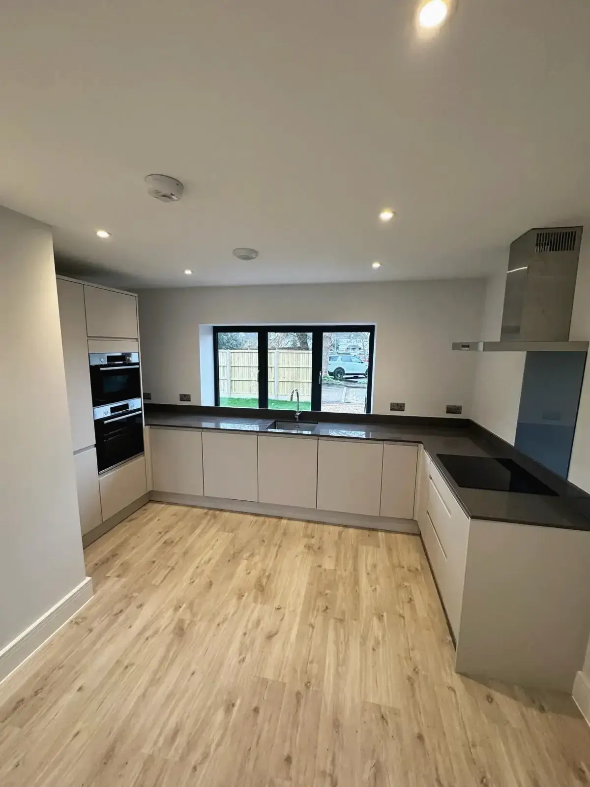 U-shaped kitchen layout with modern appliances and neutral tones