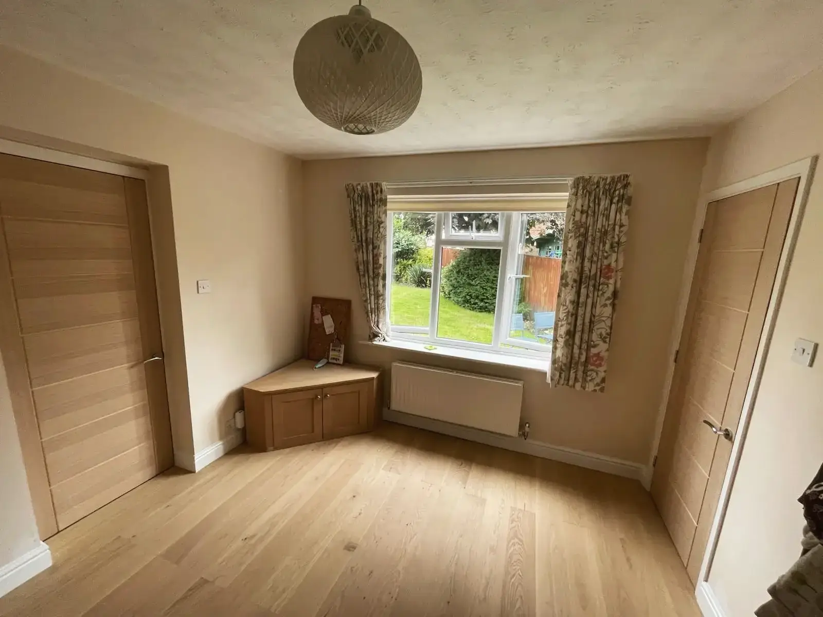 Warm extension interior with wooden doors and garden view