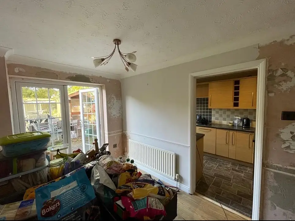 Home extension project showing interior view connecting kitchen and dining area with outdoor access by Godman Construction