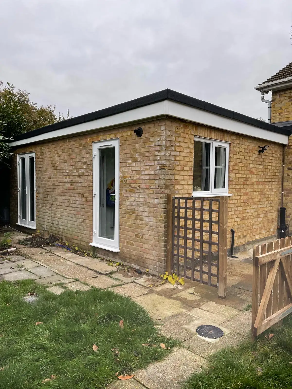 Flat roof brick extension at rear of house by Godman Construction