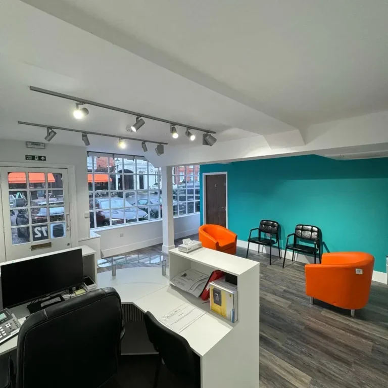 Office space with reception desk, seating area, and large front windows | Loft Conversions in Chobham by Godman Construction