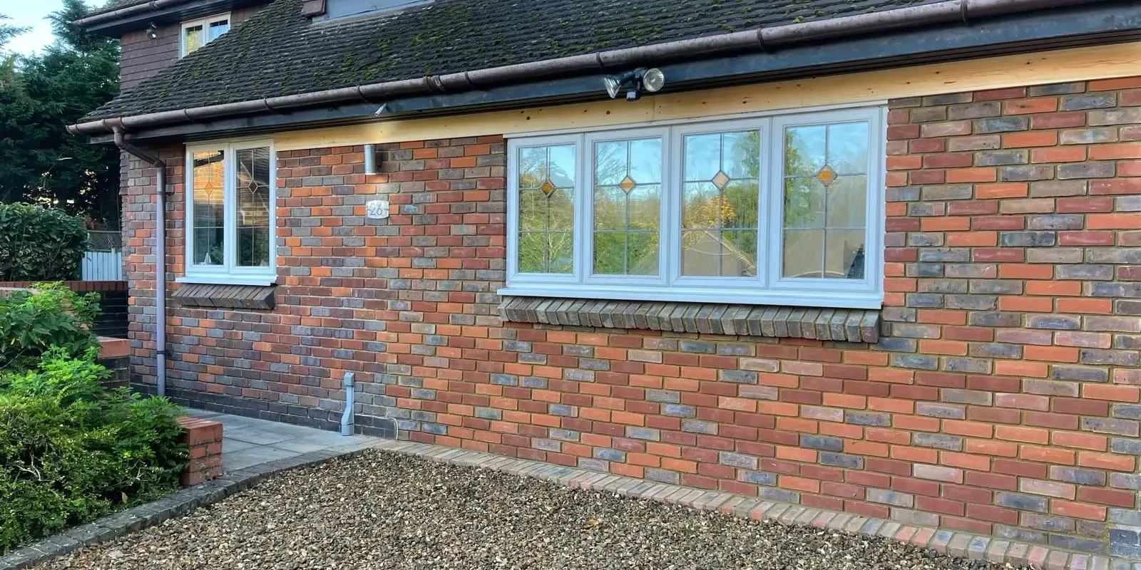 Front house renovation with decorative windows and exterior lights – Godman Construction